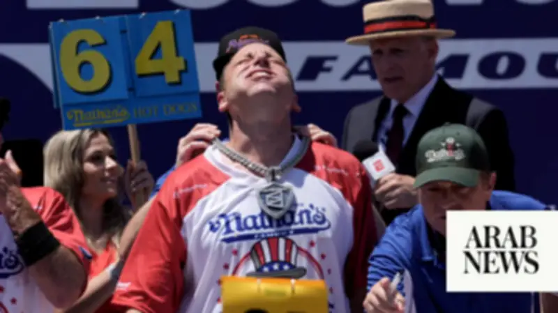 Joey Chestnut Defends Hot Dog Title Despite Heat, Eats 66