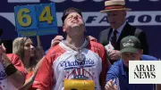 Joey Chestnut Defends Hot Dog Title Despite Heat, Eats 66